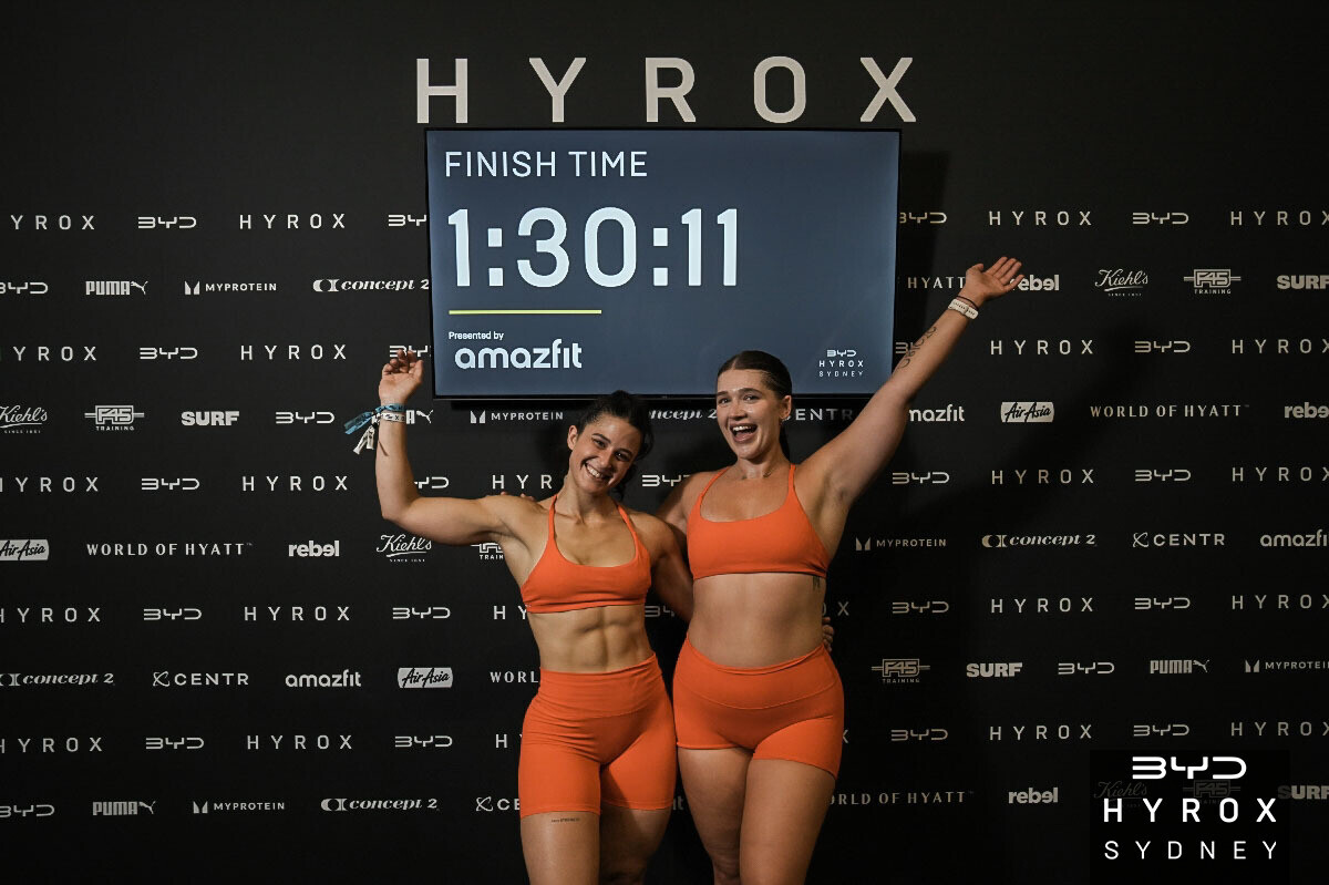 Samantha and her HYROX doubles partner celebrating their finish